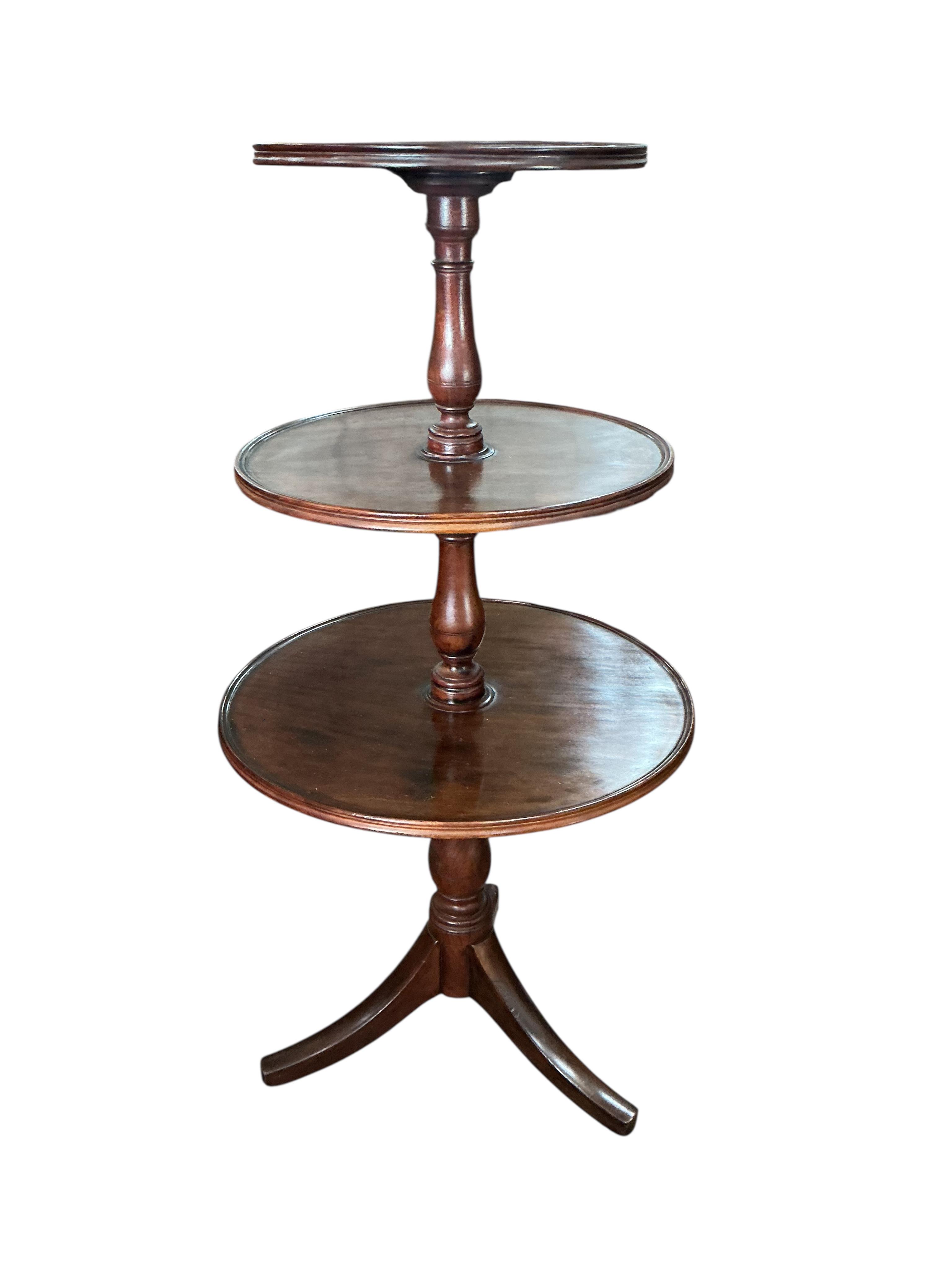 A Regency mahogany graduated three tier dumb waiter, height 125cm